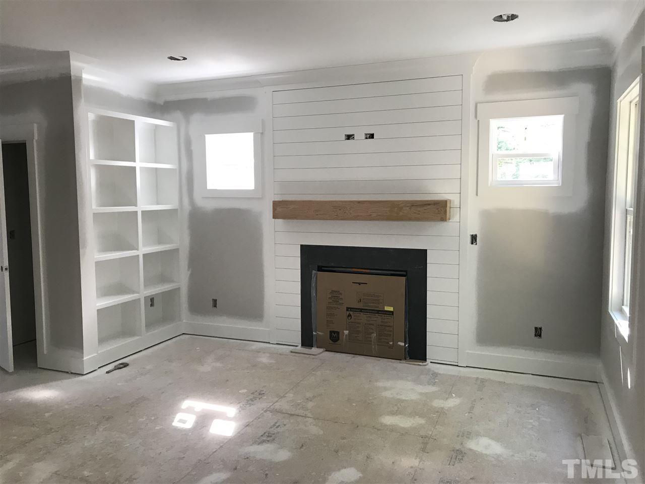 1320 Foxrun Drive Raleigh, NC 27610 - Photo 4 of 24 Shiplap with stainded wood mantel. Built Ins. Engineered hardwoods in the family room.
