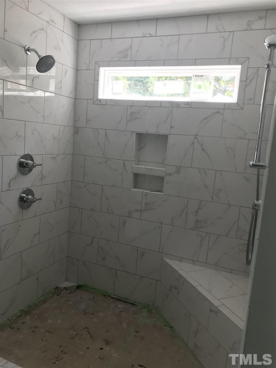 1320 Foxrun Drive Raleigh, NC 27610 - Photo 7 of 24 Large tile shower with seat. Separate shower head and shower wand