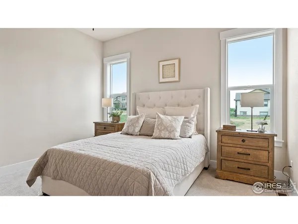 a bedroom with a bed next to a window