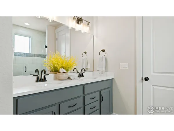 a bathroom with a sink double vanity and a mirror