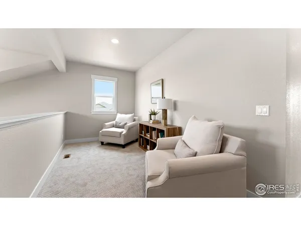 a living room with furniture and a lamp