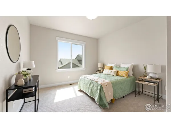 a living room with a bed furniture and a window
