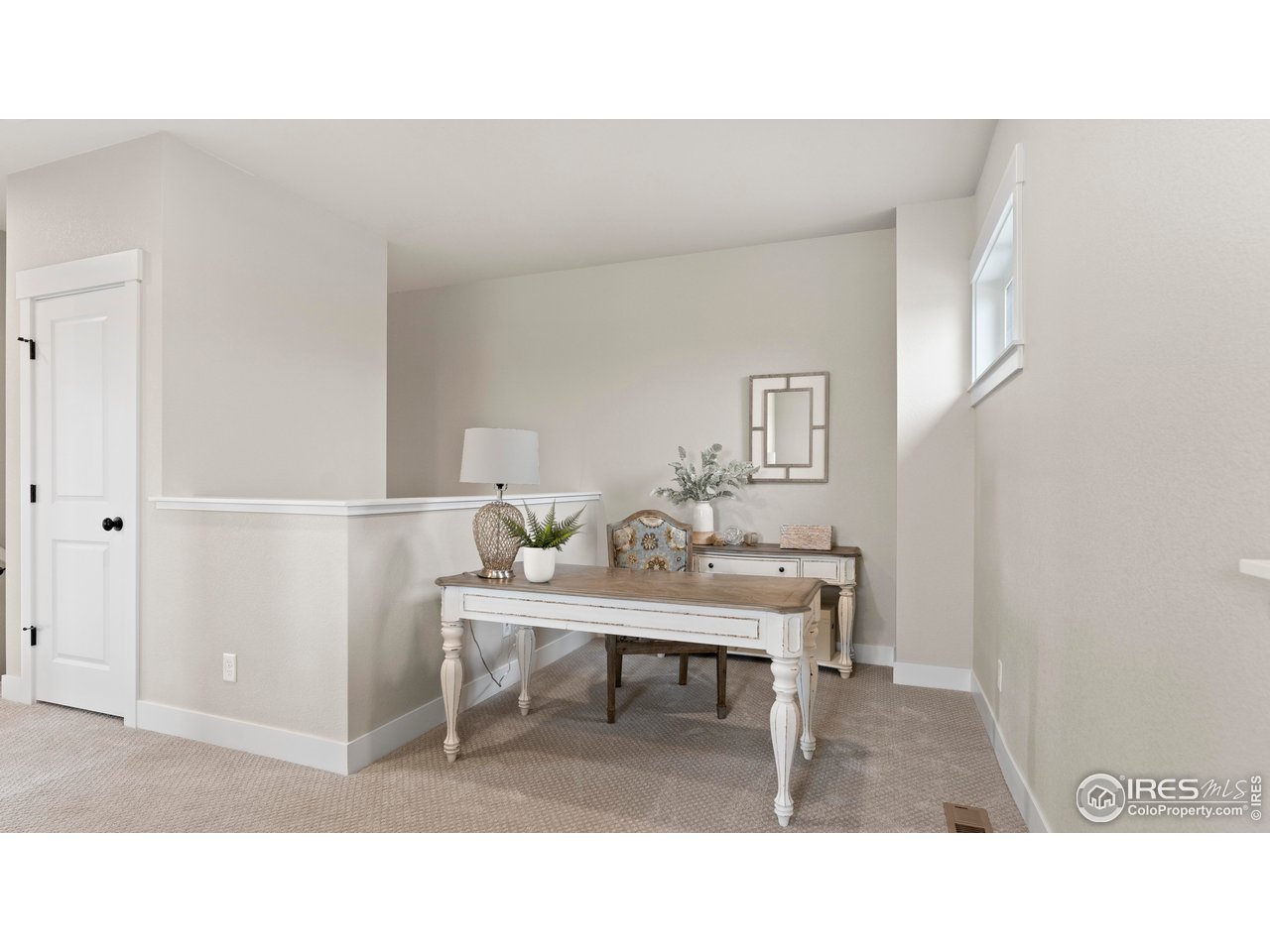 6226 Vernazza Way, Unit 4 Windsor, CO 80550 - Photo 20 of 33 a living room with a couch and a potted plant on a dresser