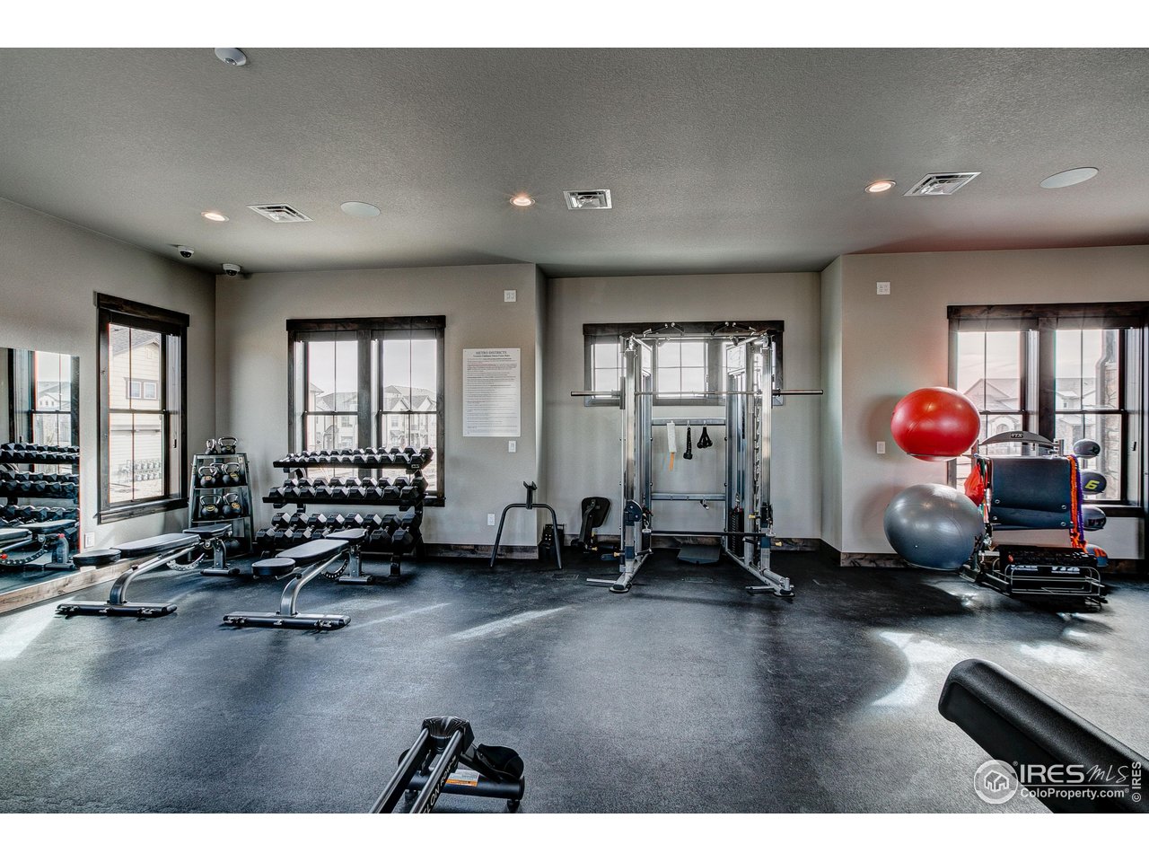 6226 Vernazza Way, Unit 4 Windsor, CO 80550 - Photo 23 of 33 a room with gym equipment and a large window