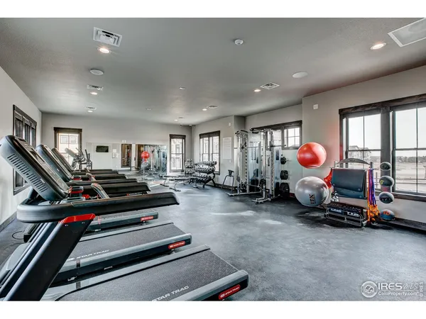 a living room with lots of gym equipment