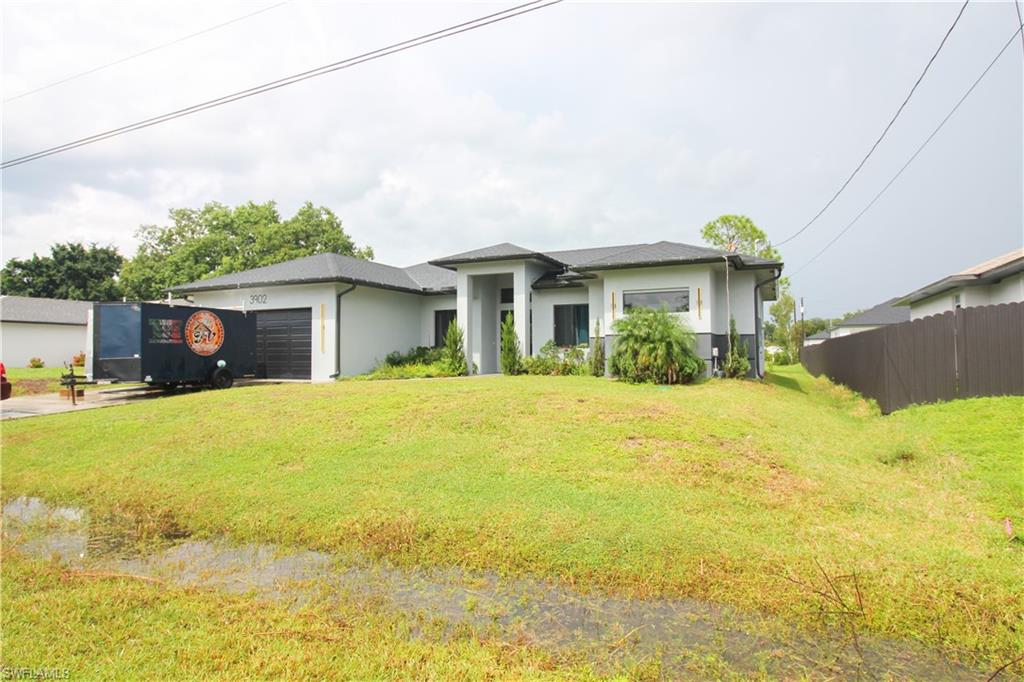 3902 4th Street Southwest Lehigh Acres, FL 33976 - Photo 4 of 34 Contemporary single-story residence with a dark asphalt shingle roof