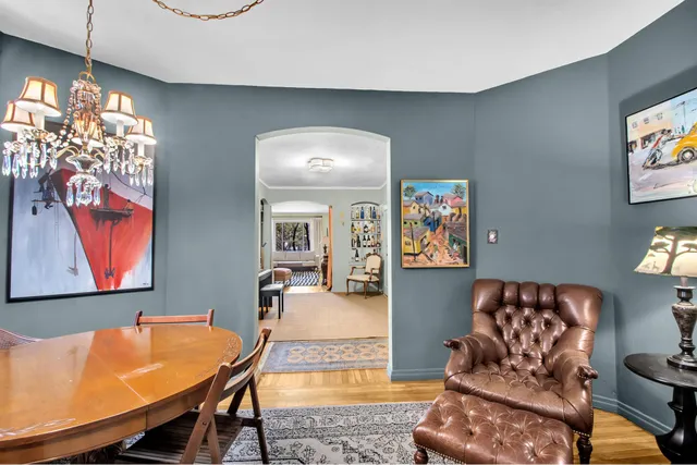 a reading room with lots of books and furniture