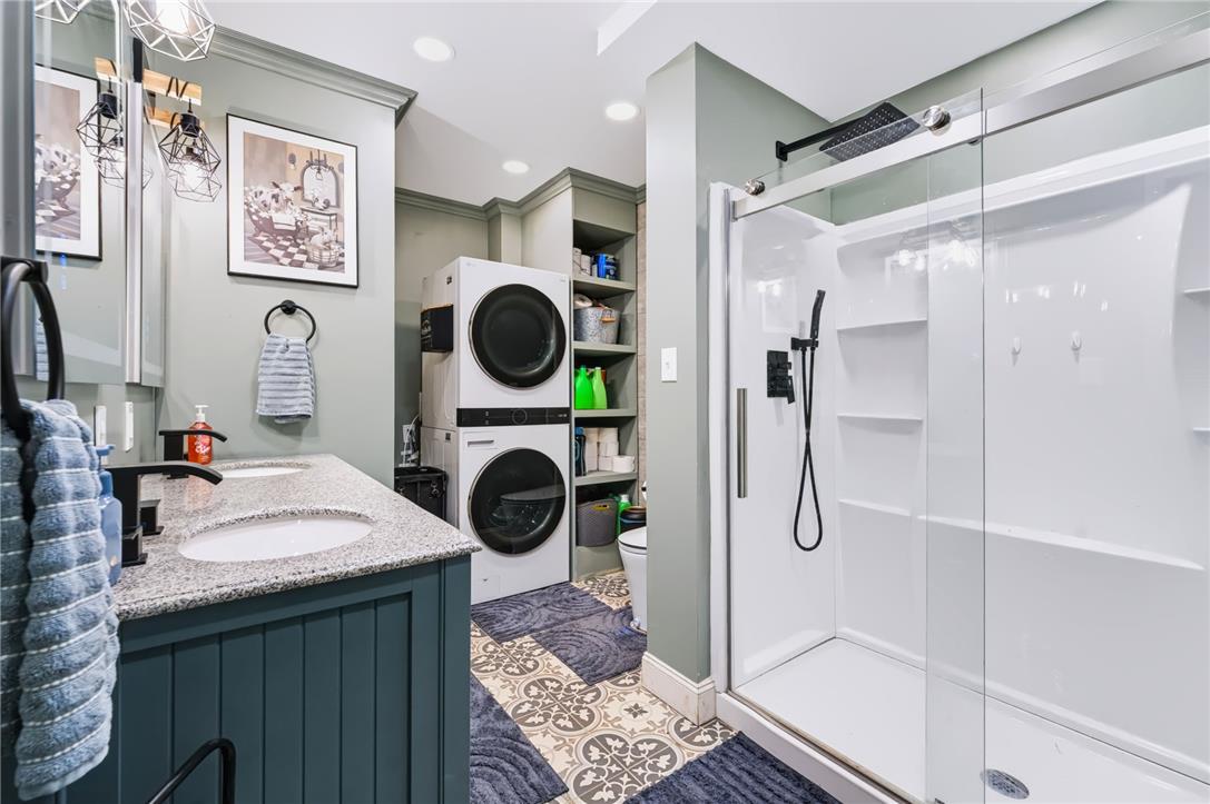 74 Turkey Road Kempton, PA 19529 - Photo 21 of 65 A well-appointed bathroom combines practical laundry facilities with a sleek, modern shower.