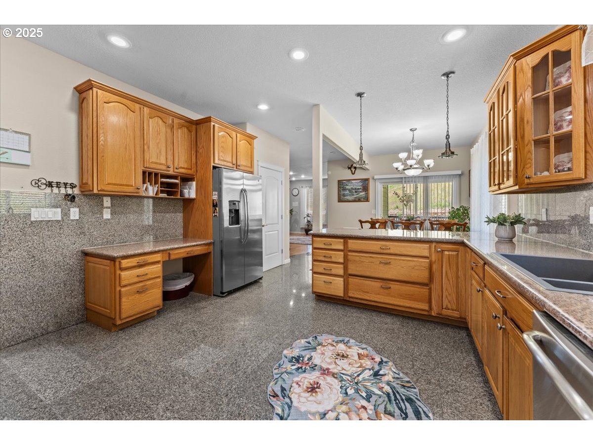 5122 Southeast Jenne Road Portland, OR 97236 - Photo 25 of 36 a kitchen that has a lot of cabinets in it and appliances