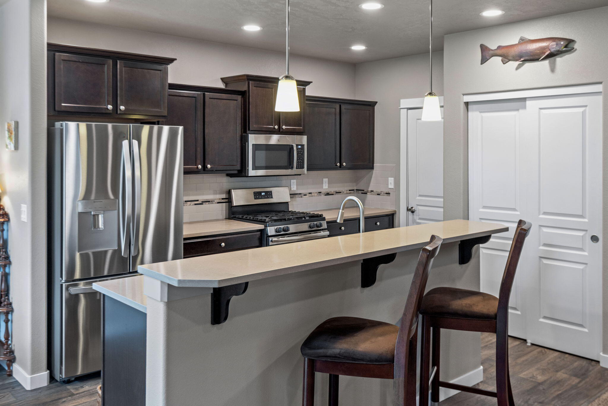 715 Brooks Camp Road Sisters, OR 97759 - Photo 7 of 25 a kitchen with stainless steel appliances a sink stove and refrigerator