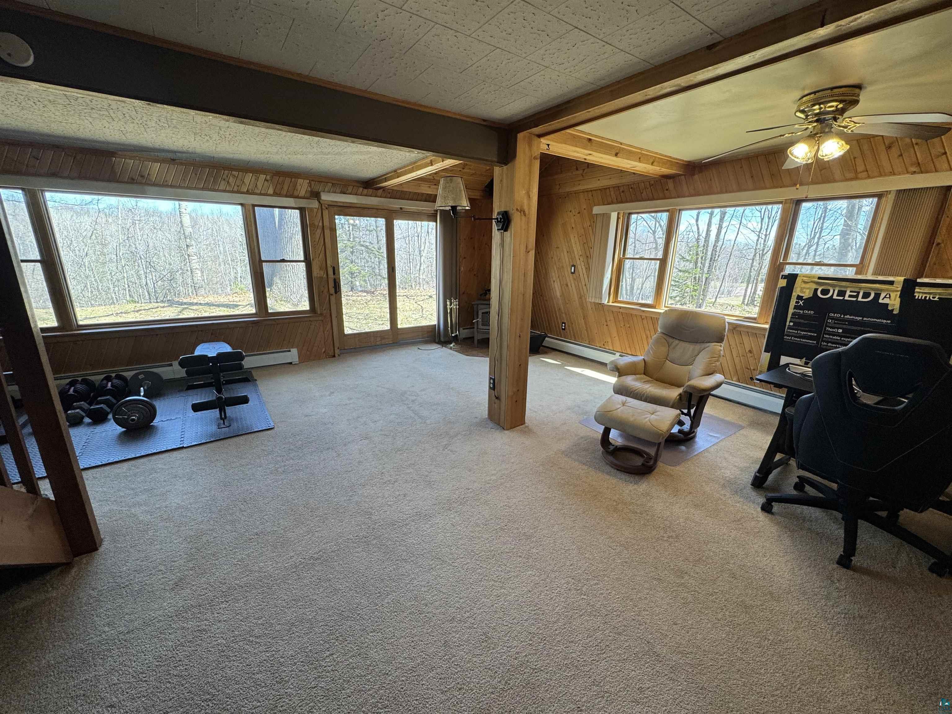 4897 Swanson Drive Maple, WI 54854 - Photo 11 of 25 Spacious living room featuring extensive natural light from multiple windows and a glass sliding door