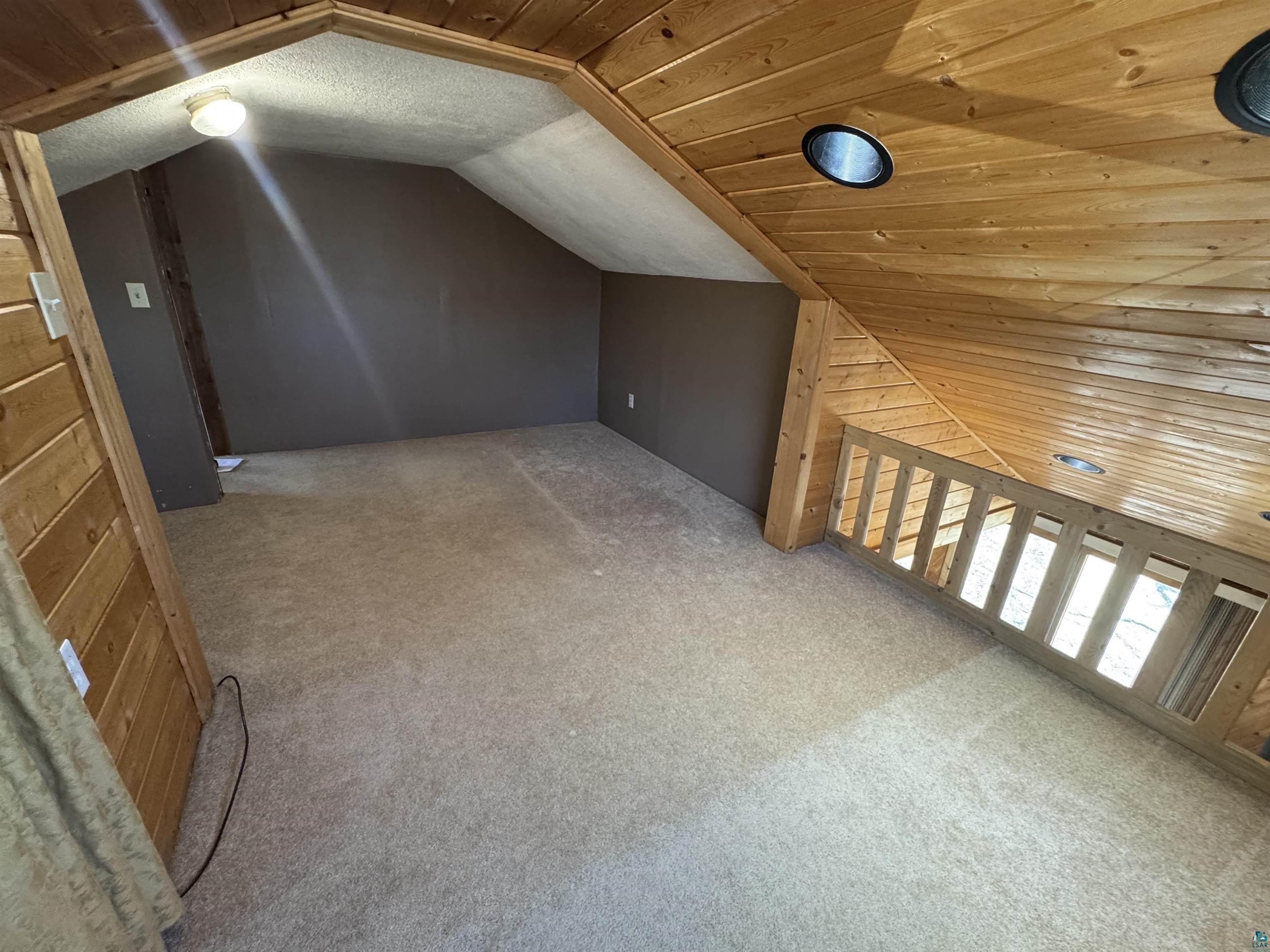 4897 Swanson Drive Maple, WI 54854 - Photo 17 of 25 Upper-level loft space featuring natural wood paneling, recessed lighting, and light-toned carpeting