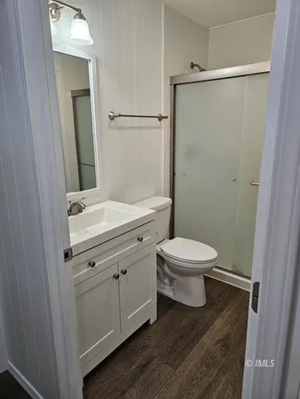 a bathroom with a toilet a sink and shower