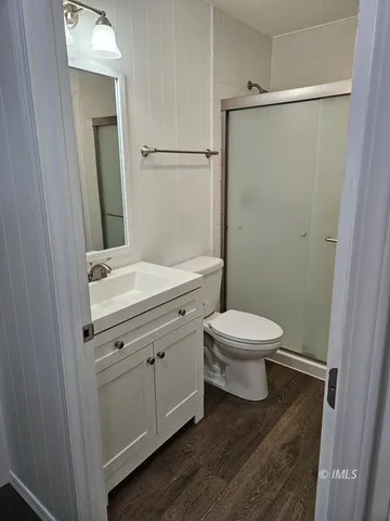 a bathroom with a toilet a sink and shower
