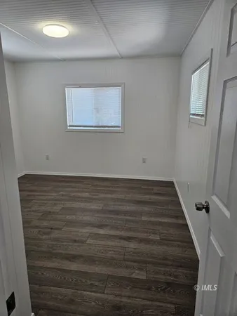 a view of room with wooden floor