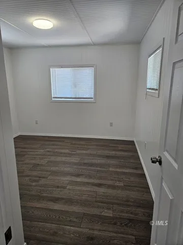 a view of room with wooden floor