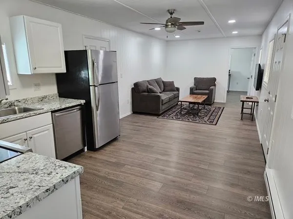a kitchen with stainless steel appliances granite countertop a refrigerator stove and sink