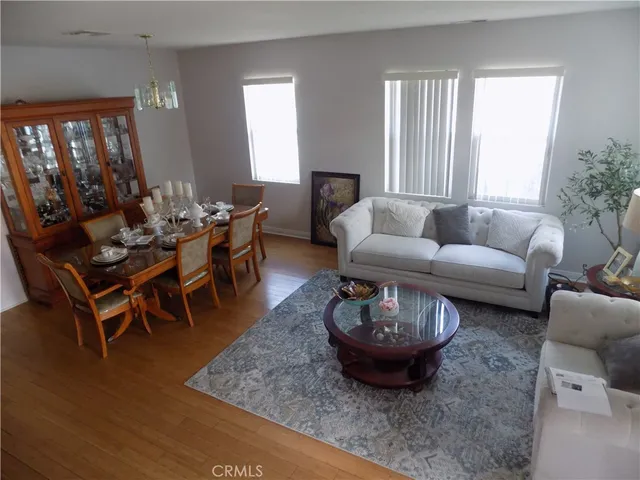 a living room with furniture a rug and a large window
