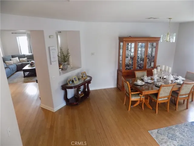 a living room with furniture a wooden floor and a large window