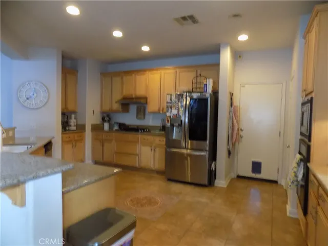 a kitchen with refrigerator and cabinets