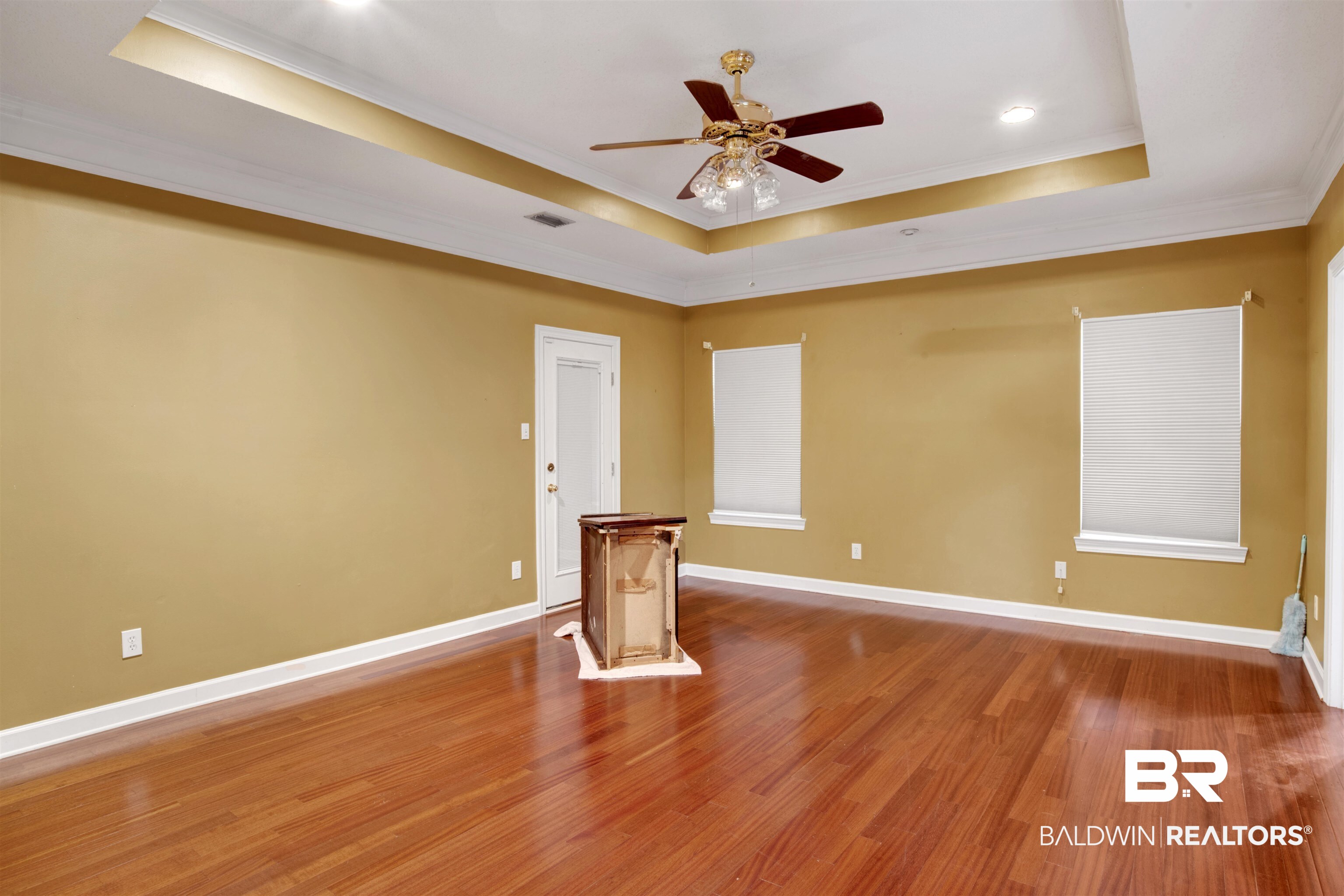 445 Wedgefield Drive South Mobile, AL 36608 - Photo 18 of 36 Unfurnished living room with hardwood / wood-style flooring, ceiling fan, a raised ceiling, and ornamental molding