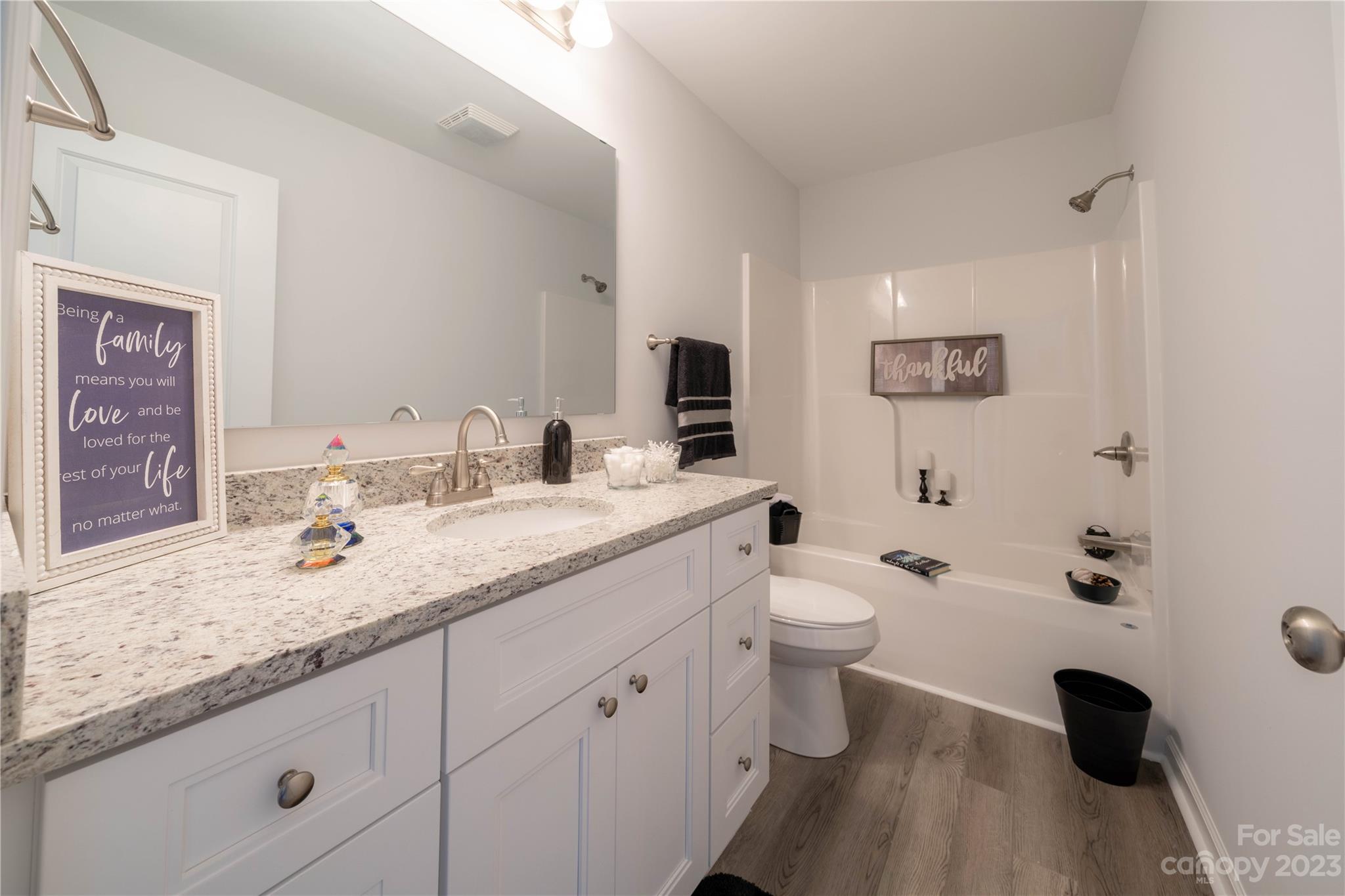121 Hawkins Loop Salisbury, NC 28144 - Photo 14 of 31 a bathroom with a granite countertop toilet sink and mirror