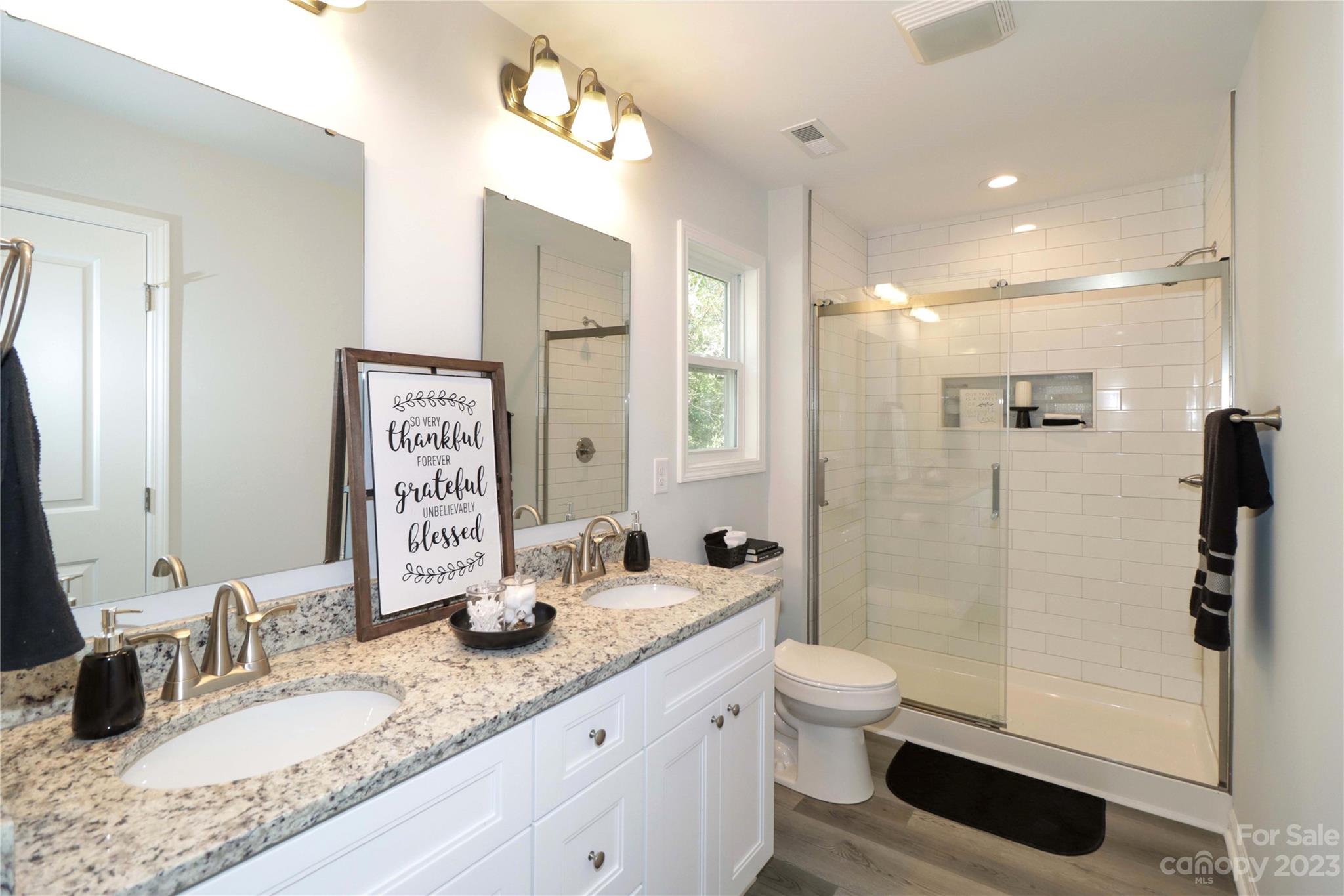 121 Hawkins Loop Salisbury, NC 28144 - Photo 10 of 31 a bathroom with a granite countertop sink toilet and shower