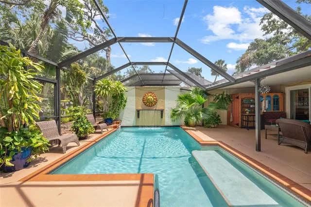 a dining room with furniture a rug a potted plant and a chandelier