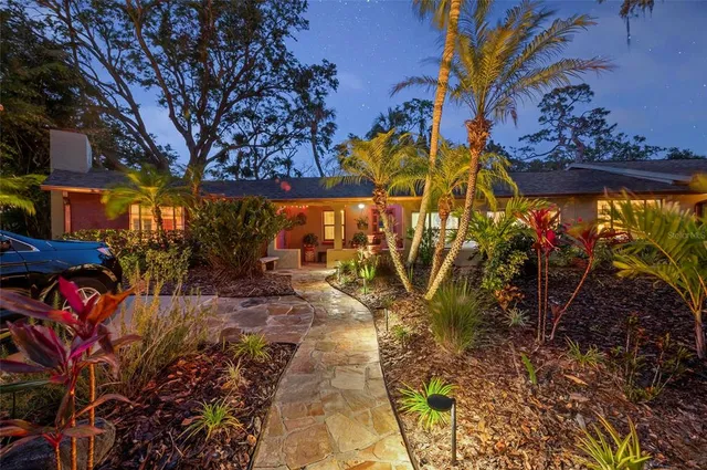 a living room with furniture a window and a potted plant