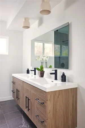 a bathroom with a double vanity sink and mirror