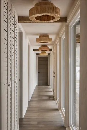 a view of a hallway with wooden floor and staircase