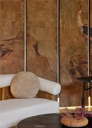 a living room with furniture and a wall