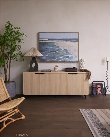 a living room with a couch and a potted plant