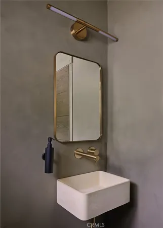 a bathroom with a sink and mirror