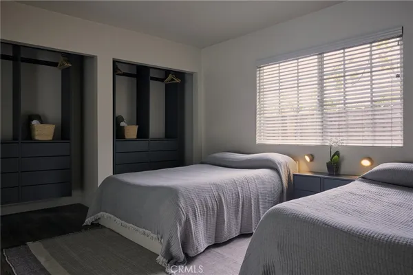 a bedroom with two beds and a window