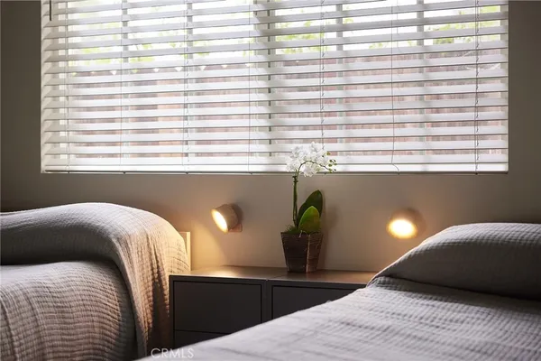 a bedroom with a bed and window