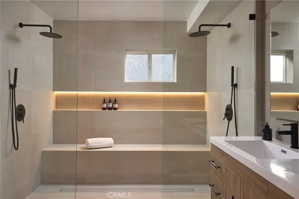 a bathroom with a tub sink and mirror