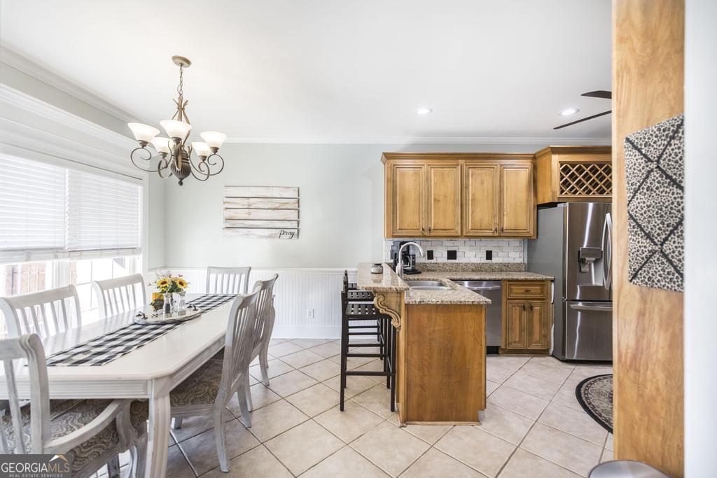 103 Westward Point Kathleen, GA 31047 - Photo 13 of 47 a dining room with stainless steel appliances granite countertop a dining table and chairs
