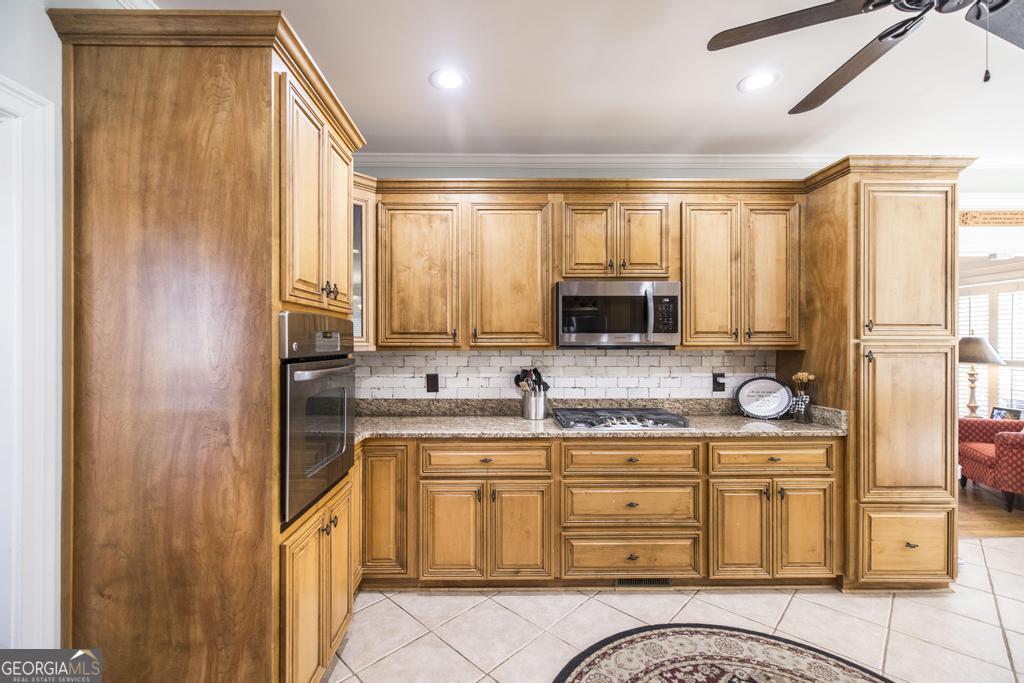 103 Westward Point Kathleen, GA 31047 - Photo 18 of 47 a kitchen with stainless steel appliances granite countertop a stove a sink and a microwave