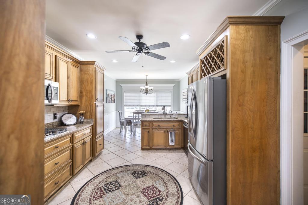 103 Westward Point Kathleen, GA 31047 - Photo 19 of 47 a kitchen with stainless steel appliances granite countertop a refrigerator a stove and a sink with wooden floor