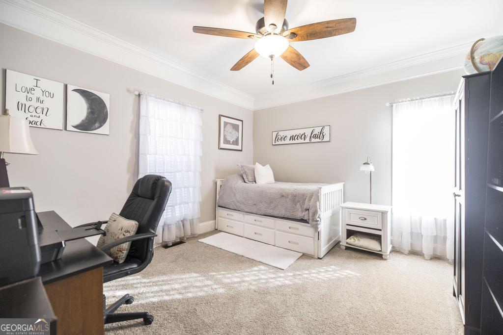 103 Westward Point Kathleen, GA 31047 - Photo 26 of 47 a bedroom with a bed and a chandelier