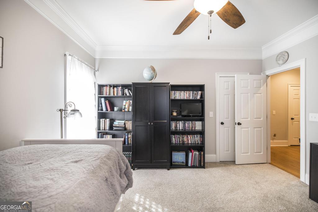 103 Westward Point Kathleen, GA 31047 - Photo 27 of 47 a bedroom with a large bed and a chandelier