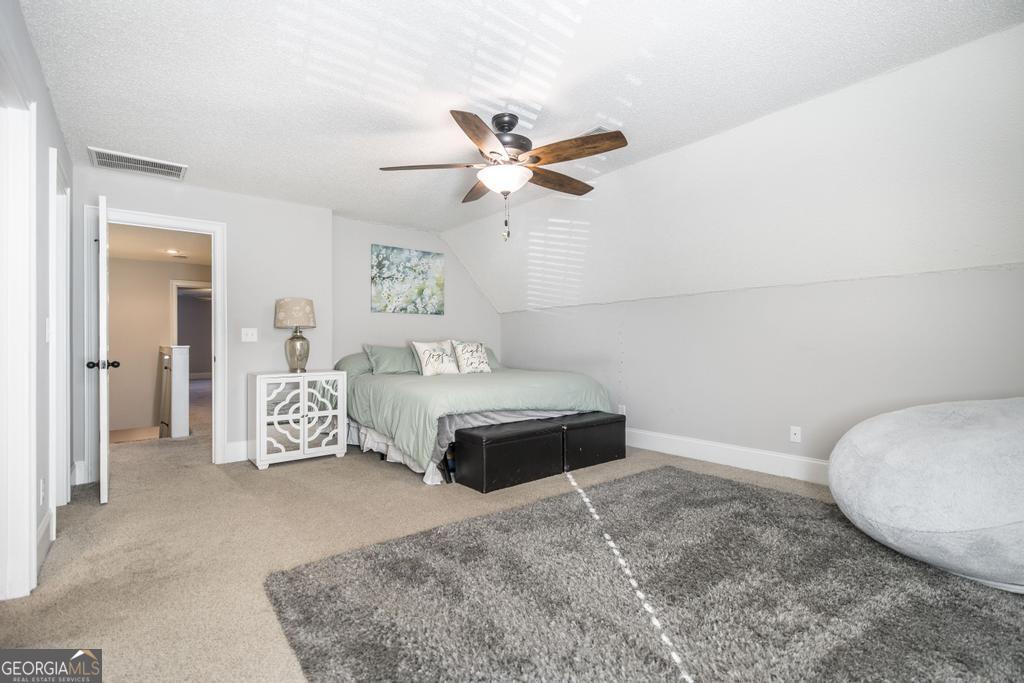 103 Westward Point Kathleen, GA 31047 - Photo 33 of 47 a bedroom with a bed and a chandelier