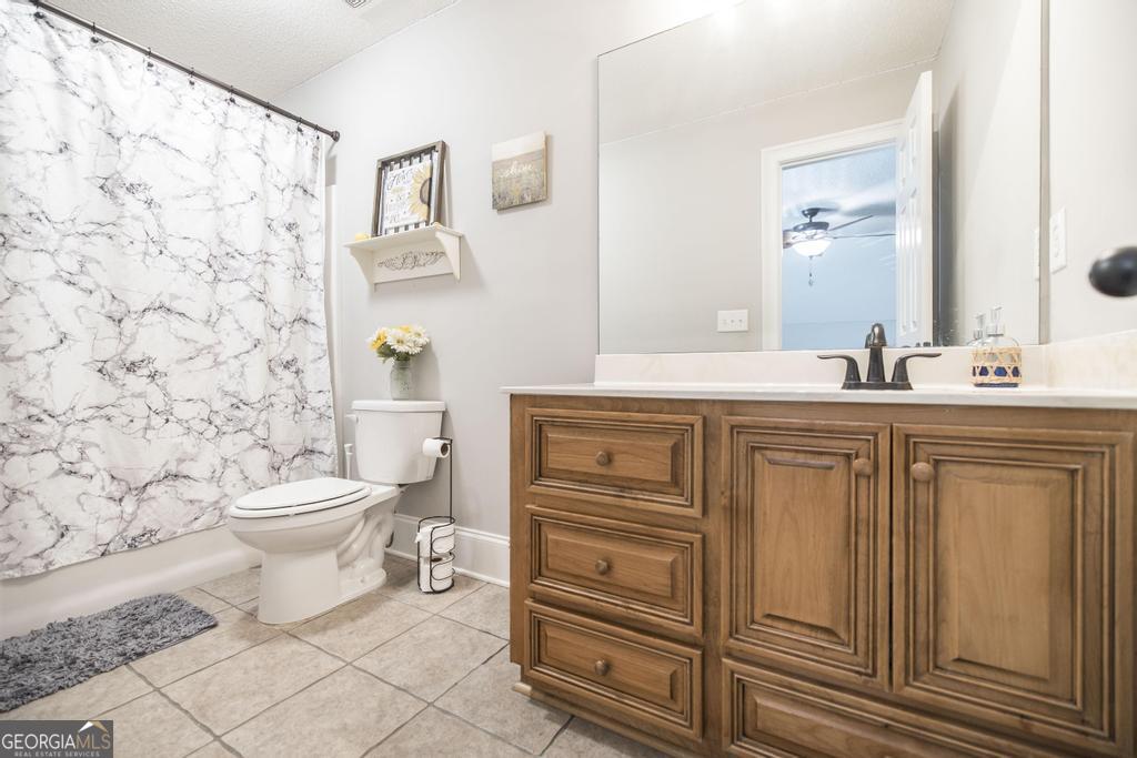 103 Westward Point Kathleen, GA 31047 - Photo 34 of 47 a bathroom with a granite countertop toilet sink and a mirror