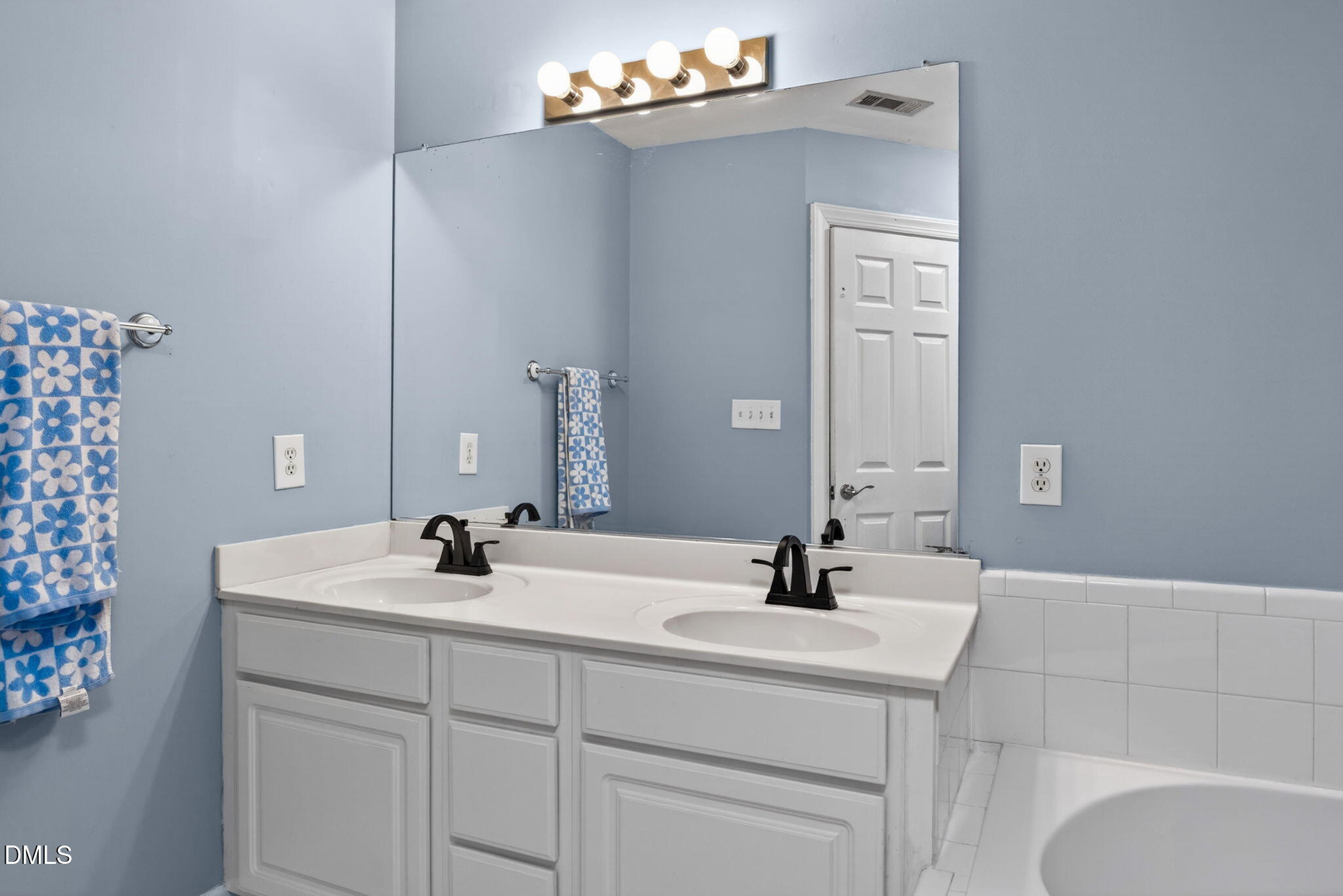 5500 Vista View Court Raleigh, NC 27612 - Photo 29 of 38 a bathroom with a sink and a mirror