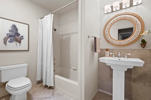 a bathroom with a sink a toilet and a shower