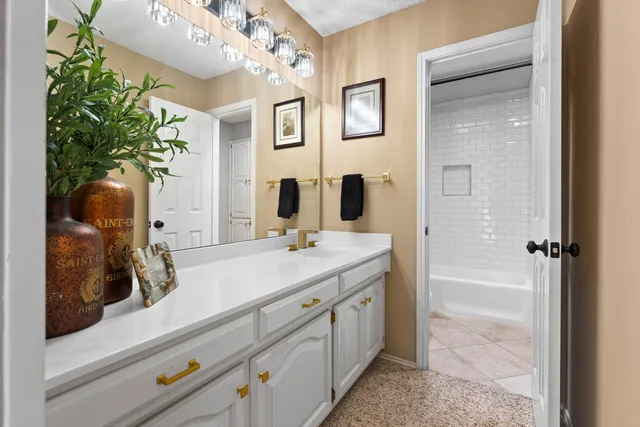 a spacious bathroom with a double vanity sink and a mirror