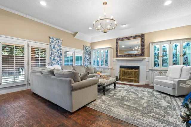 a living room with furniture a large window and a fireplace