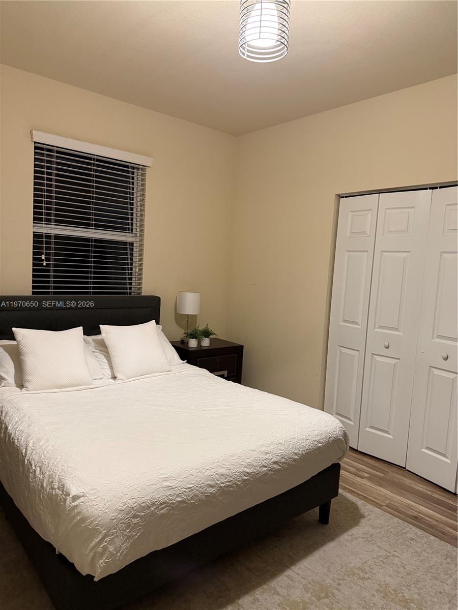 17012 Southwest 91st Street Miami, FL 33196 - Photo 22 of 22 a bedroom with a bed and a window
