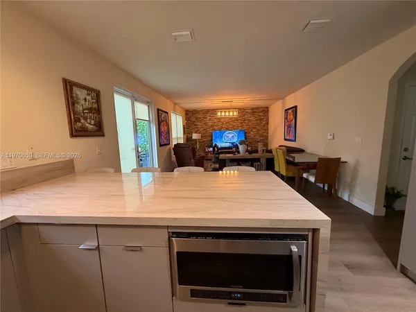 a kitchen with stainless steel appliances a stove microwave and refrigerator